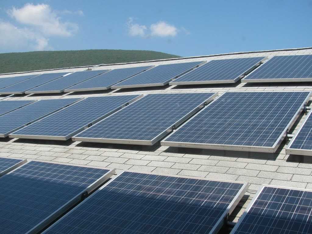 Rows of solar panels on a flat commercial roof