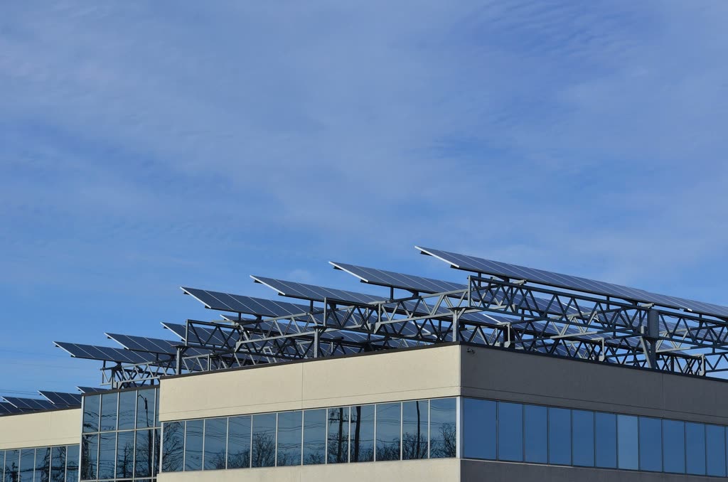 Solar panels racked on the roof of an office building